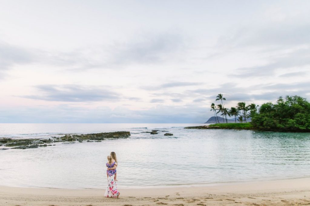 mom and daughter at a quiet lagoon in ko olina hawaii