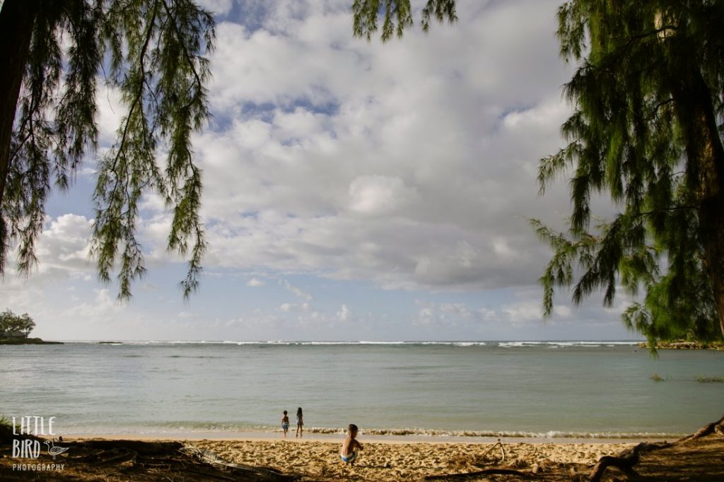 kids heading out to play in the water at kawela bay oahu