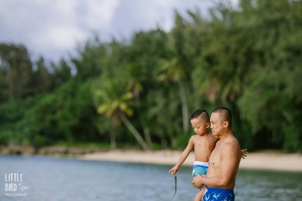 dad holding son at the beach on the north shore of oahu