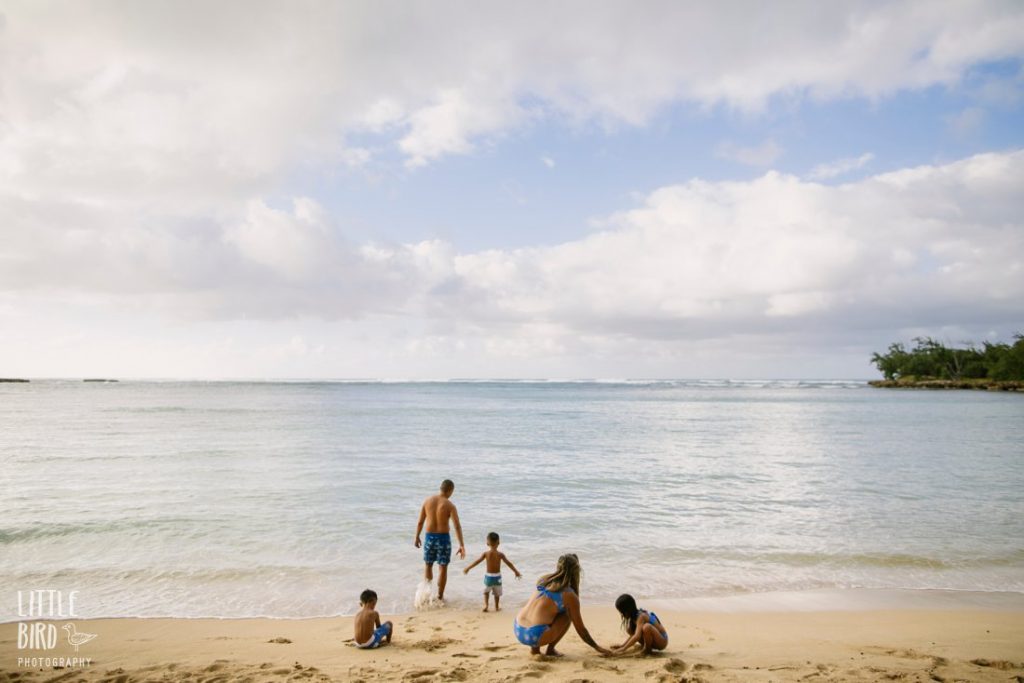 family wearing of one sea swimsuits during a photo shoot on the north shore of oahu