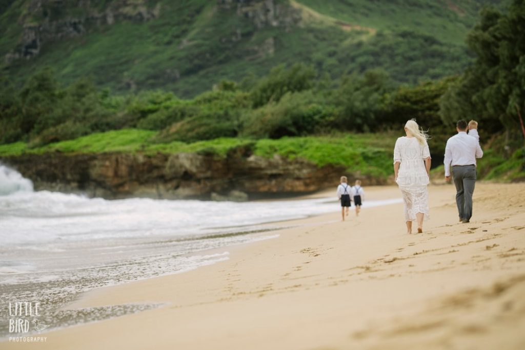 family walking along laie beach