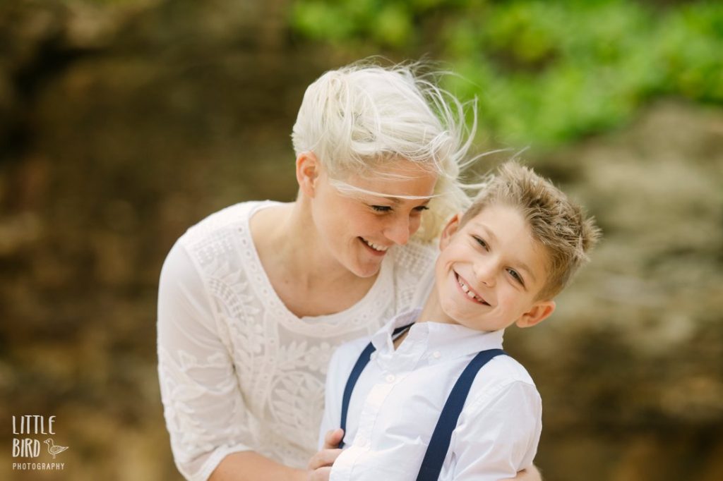 mom and son sharing a laugh during fun family photo session in hawaii