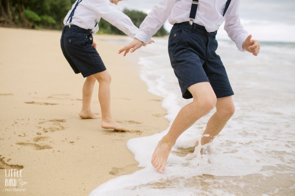 boys playing in the surf in hawaii