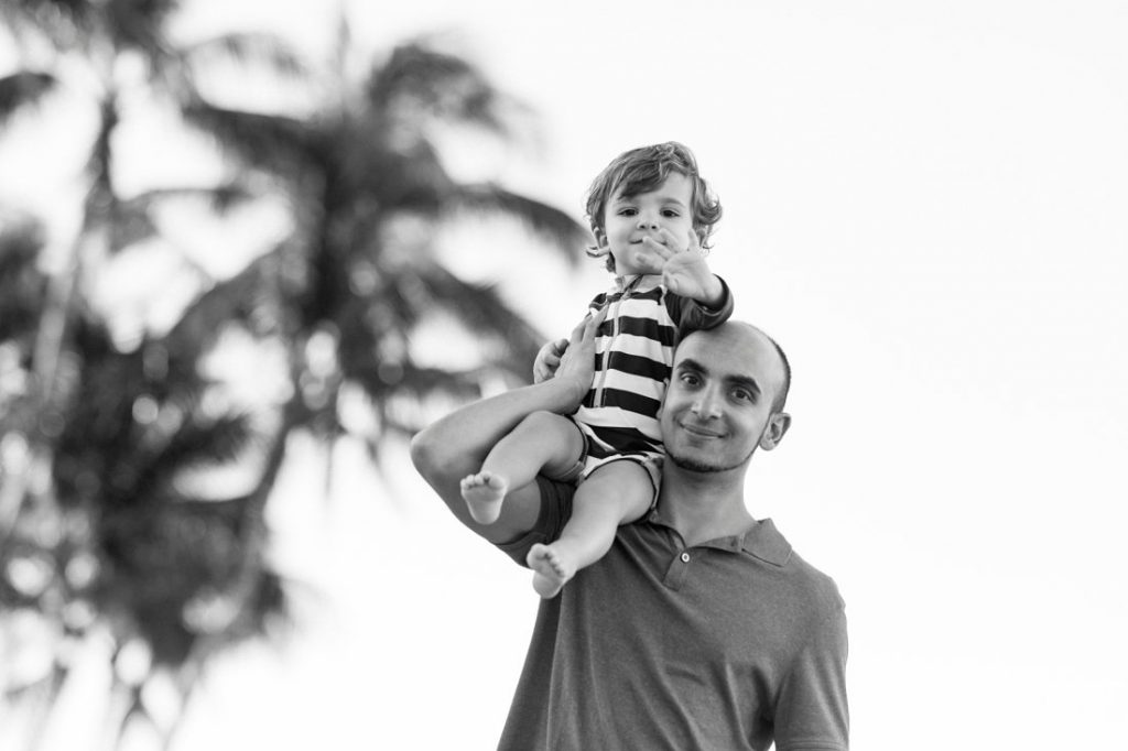 dad carry son on his shoulder