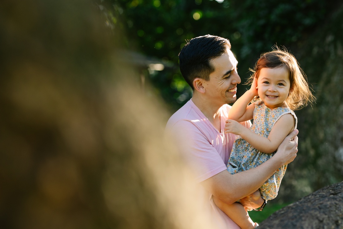 dad and toddler daughter playing during a family photo session in hawaii